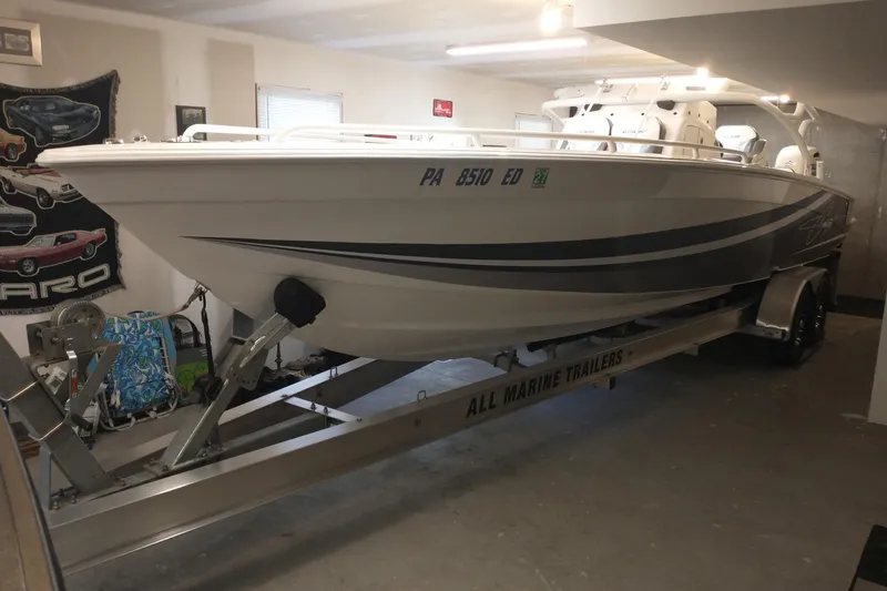 Slide: The Image of 2019 Concept 30' Open Deck boat on trailer in garage setting. - 7