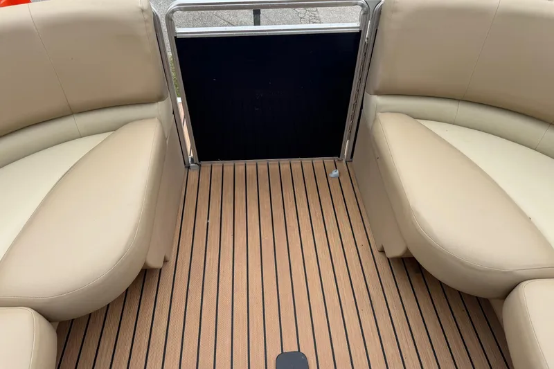 Slide: The Image of Interior view of 2015 Harris FloteBote 220 Cruiser CX with beige seating and wood-style flooring. - 11