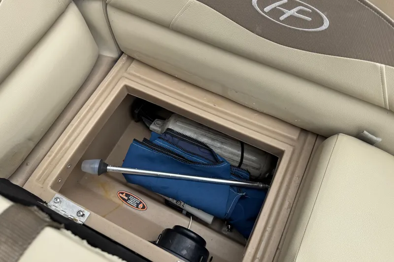 Slide: The Image of Storage compartment in a 2015 Harris FloteBote 220 Cruiser CX with boating accessories. - 13