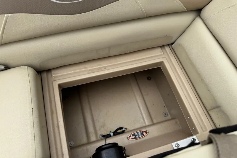Slide: The Image of Storage compartment in 2015 Harris FloteBote 220 Cruiser CX boat with beige seating. - 15