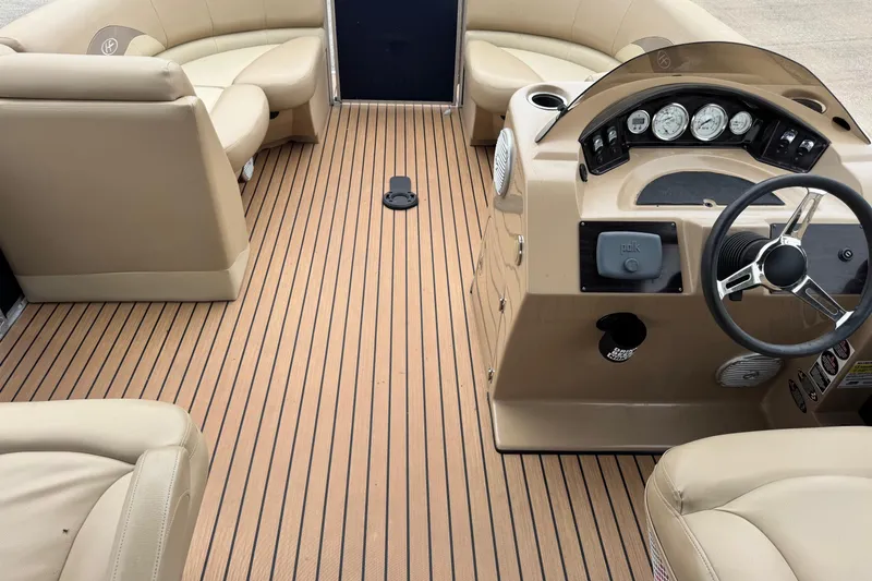 Slide: The Image of 2015 Harris FloteBote 220 Cruiser CX interior with beige seating and wood-style flooring. - 17