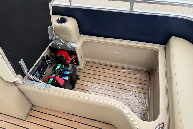 Slide: The Image of 2015 Harris FloteBote 220 Cruiser CX interior storage with battery and wiring. - 21