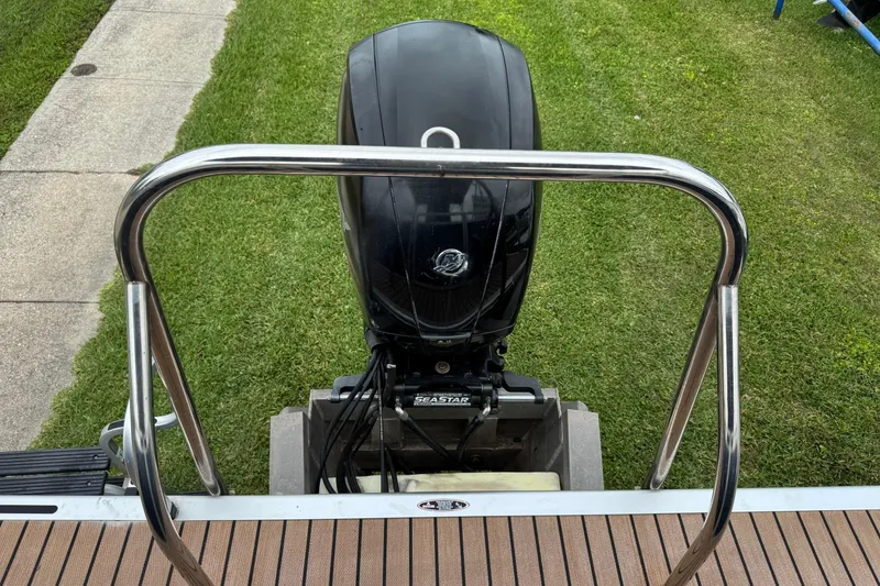 Slide: The Image of 2015 Harris FloteBote 220 Cruiser CX with Mercury outboard motor on grass. - 22