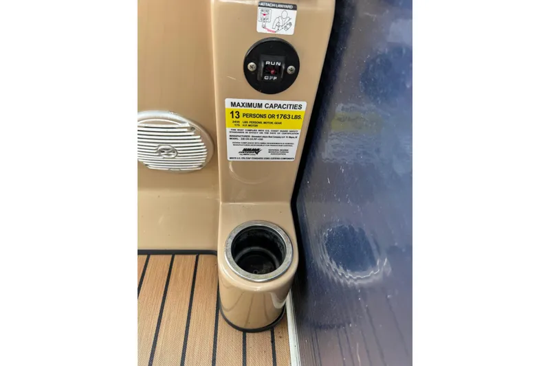 Slide: The Image of 2015 Harris FloteBote 220 Cruiser CX interior, showing capacity label and cup holder. - 23