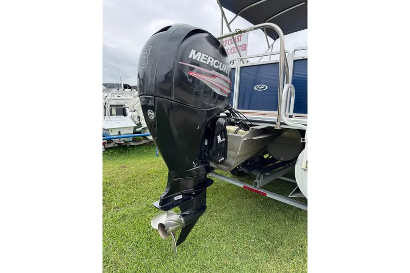 Slide: The Image of 2015 Harris FloteBote 220 Cruiser CX with Mercury outboard motor on grassy area. - 24