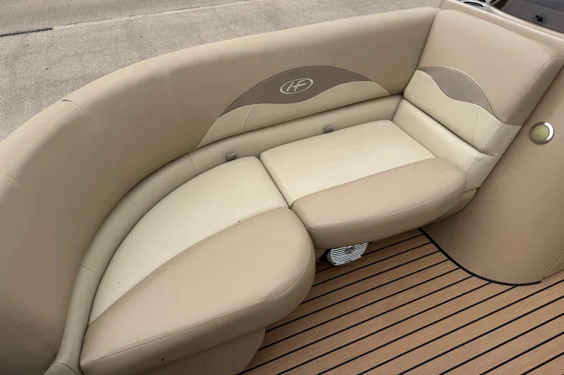 Slide: The Image of 2015 Harris FloteBote 220 Cruiser CX, beige seating, wooden deck, elegant design. - 9