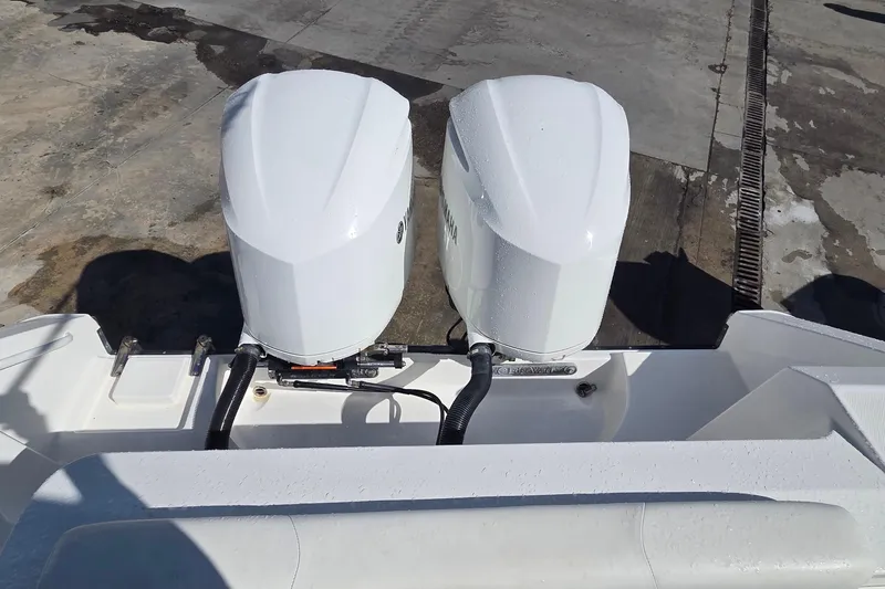 Slide: The Image of Twin outboard engines on a 2018 Edgewater 280CC boat, dockside view. - 11
