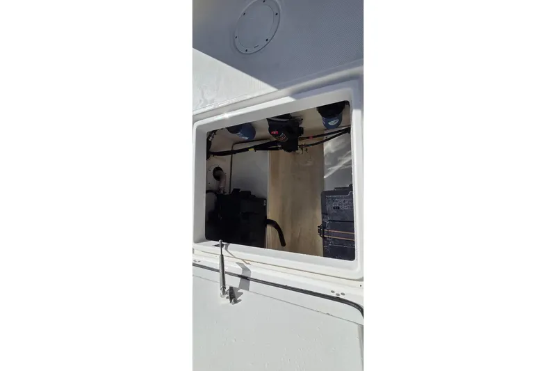 Slide: The Image of Interior compartment of a 2018 Edgewater 280CC boat, showcasing wiring and equipment. - 15
