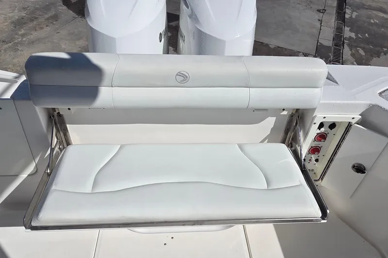 Slide: The Image of 2018 Edgewater 280CC boat with white cushioned seating and dual Yamaha engines. - 16
