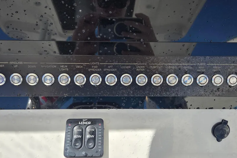 Slide: The Image of Control panel of a 2018 Edgewater 280CC boat with various switches and buttons. - 18