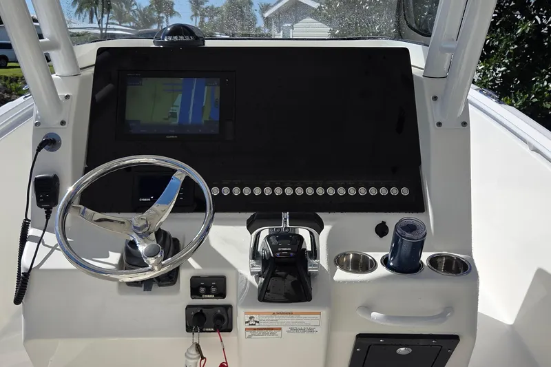Slide: The Image of 2018 Edgewater 280CC boat dashboard with steering wheel and navigation system. - 19