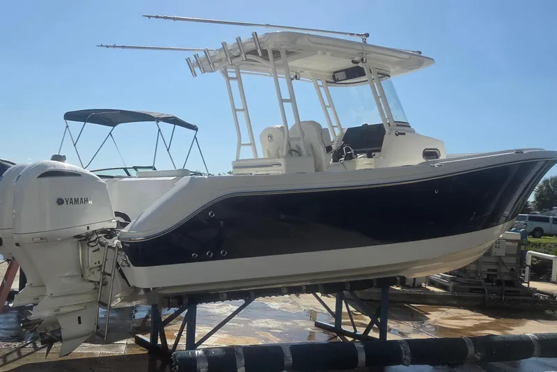 Slide: The Image of 2018 Edgewater 280CC boat with Yamaha outboard engines on display. - 2