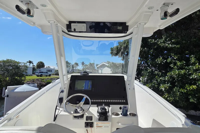 Slide: The Image of Cockpit view of 2018 Edgewater 280CC boat with steering wheel and navigation display. - 20
