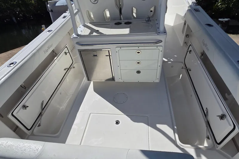Slide: The Image of 2018 Edgewater 280CC boat interior with storage compartments and seating area. - 21