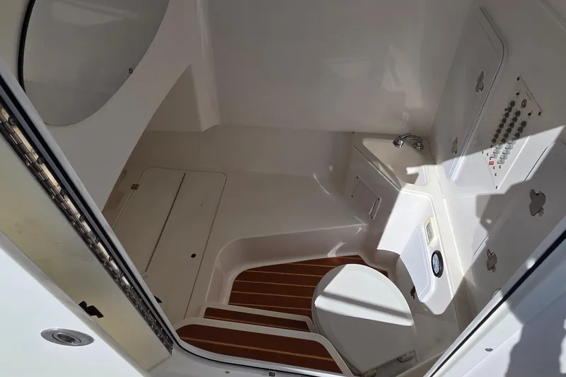Slide: The Image of Interior of a 2018 Edgewater 280CC boat, featuring a compact cabin space. - 22