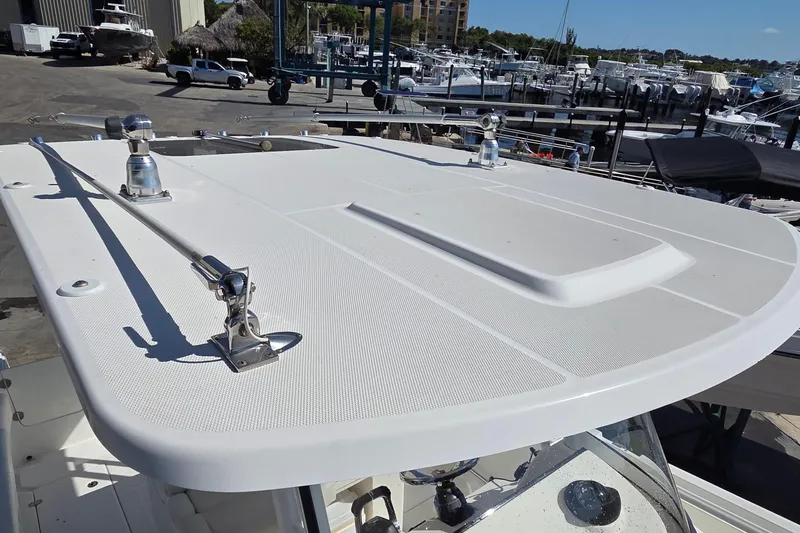Slide: The Image of 2018 Edgewater 280CC boat rooftop view at marina with clear sky. - 24