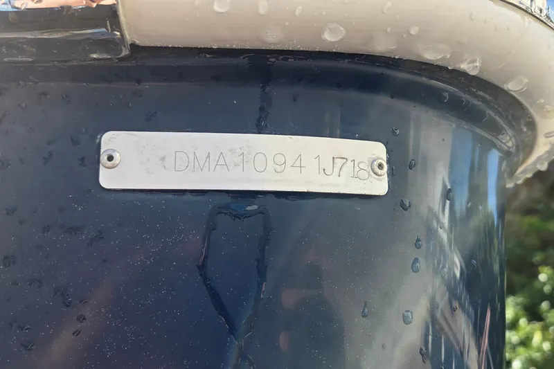 Slide: The Image of 2018 Edgewater 280CC boat hull identification number plate with water droplets. - 27