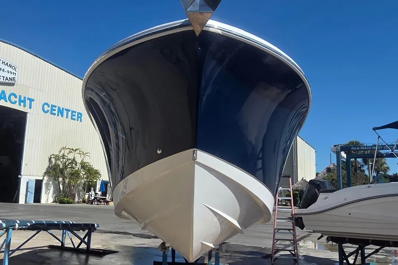 Slide: The Image of 2018 Edgewater 280CC boat at yacht center, blue hull, sunny day. - 4