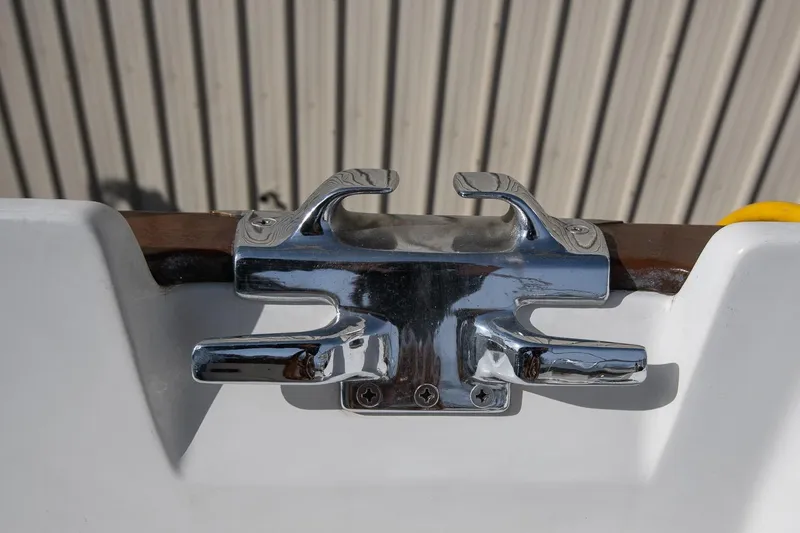 Slide: The Image of Chrome cleat on a 1999 Gozzard 37A sailboat, mounted on a wooden rail. - 12