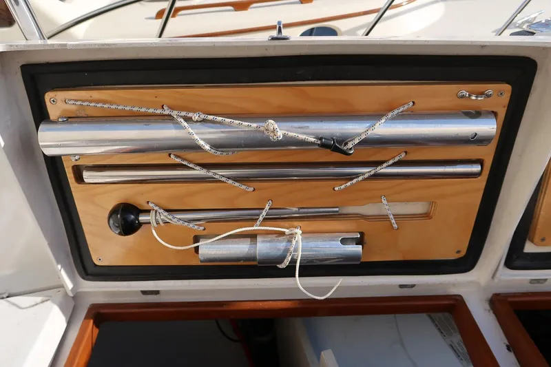 Slide: The Image of Storage compartment on a 1999 Gozzard 37A sailboat with secured metal tools and ropes. - 13