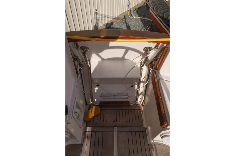 Slide: The Image of 1999 Gozzard 37A yacht cockpit with wooden accents and nautical equipment. - 15