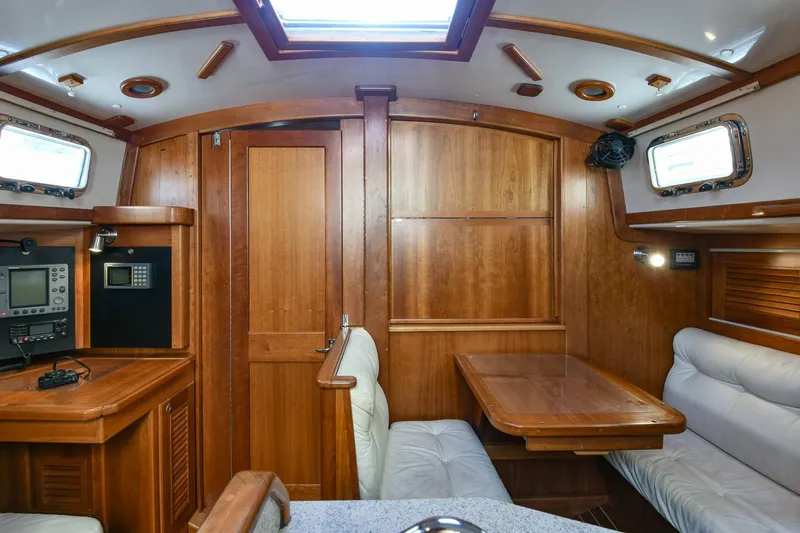 Slide: The Image of Interior of a 1999 Gozzard 37A sailboat with wooden finishes and seating area. - 17