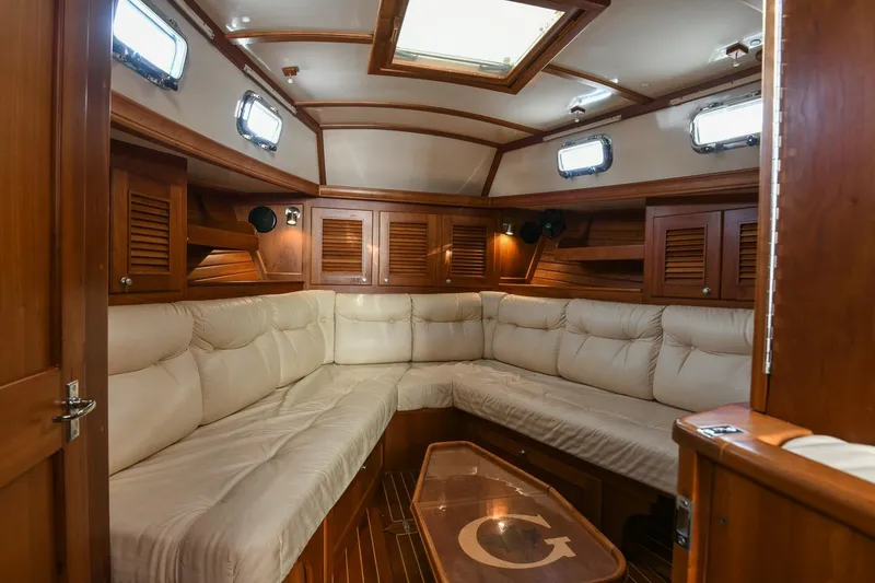 Slide: The Image of Luxurious interior of a 1999 Gozzard 37A yacht with plush seating and wooden finishes. - 18