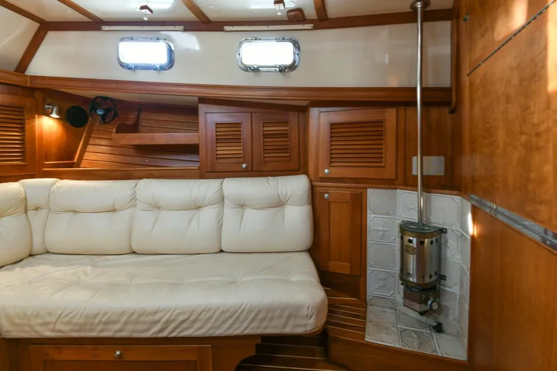 Slide: The Image of Cozy interior of 1999 Gozzard 37A yacht with wooden paneling and cushioned seating. - 20