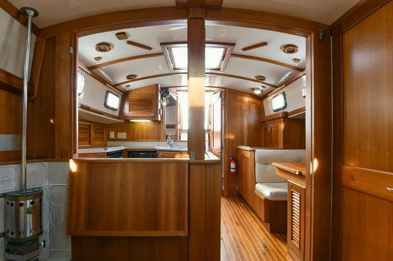 Slide: The Image of Interior of 1999 Gozzard 37A yacht with wooden finishes and cozy seating area. - 23