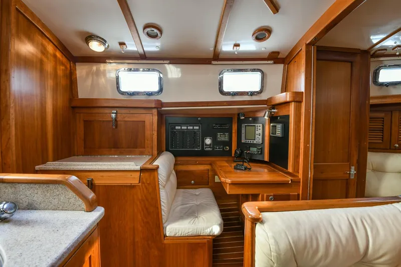 Slide: The Image of 1999 Gozzard 37A yacht interior with wooden cabinetry and navigation equipment. - 27