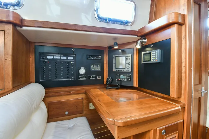 Slide: The Image of Navigation station of a 1999 Gozzard 37A yacht with control panels and wooden finish. - 29