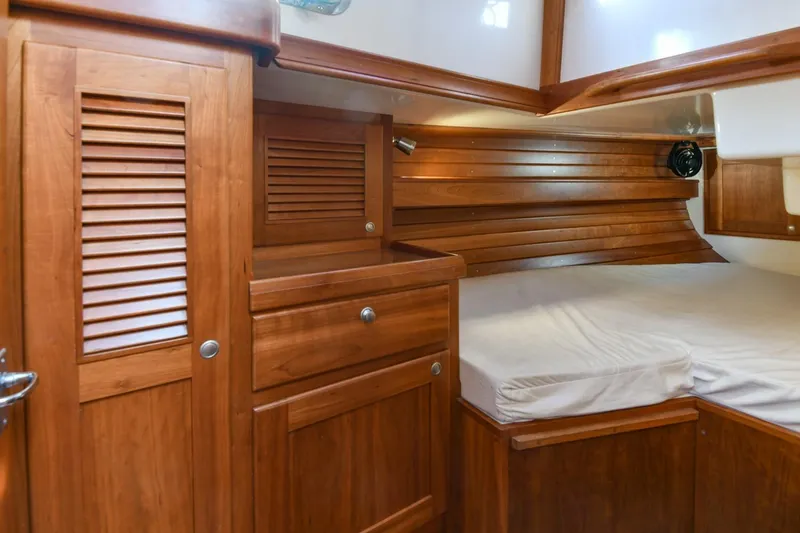 Slide: The Image of Interior of 1999 Gozzard 37A sailboat with wooden cabinetry and cozy sleeping area. - 30