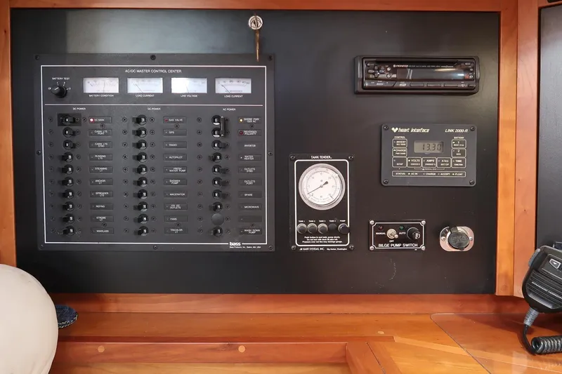Slide: The Image of Electrical control panel of a 1999 Gozzard 37A yacht, featuring various switches and gauges. - 32