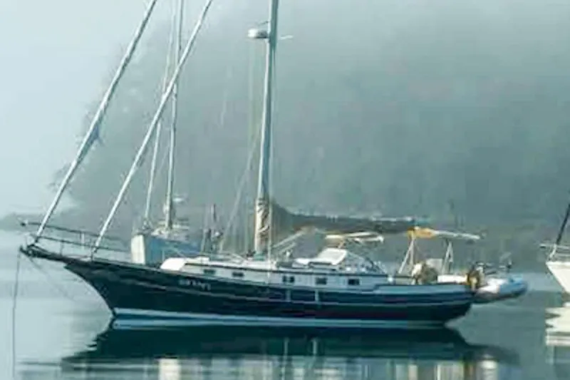 Slide: The Image of Sailboat Gozzard 37A, 1999 model, anchored in calm waters with misty background. - 33