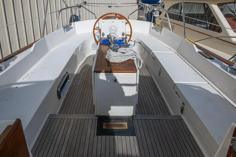 Slide: The Image of Cockpit of a 1999 Gozzard 37A sailboat with wooden accents and steering wheel. - 4