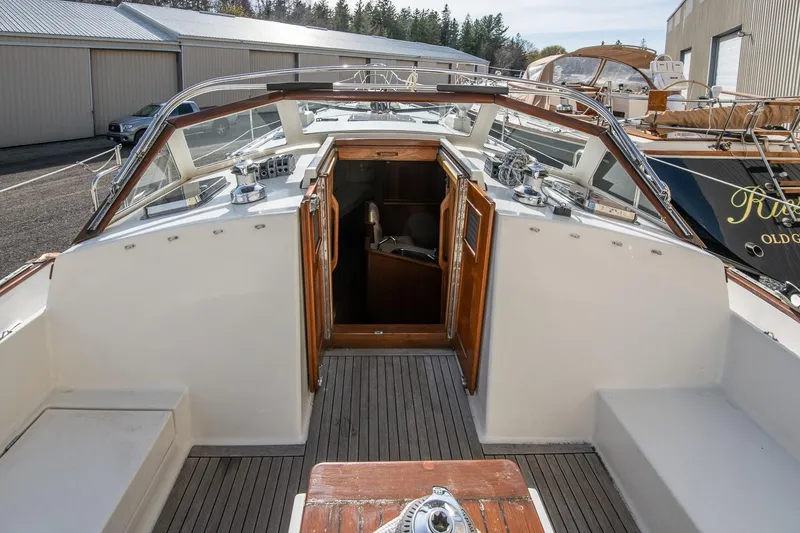 Slide: The Image of 1999 Gozzard 37A sailboat cockpit with wooden accents and open cabin entrance. - 6