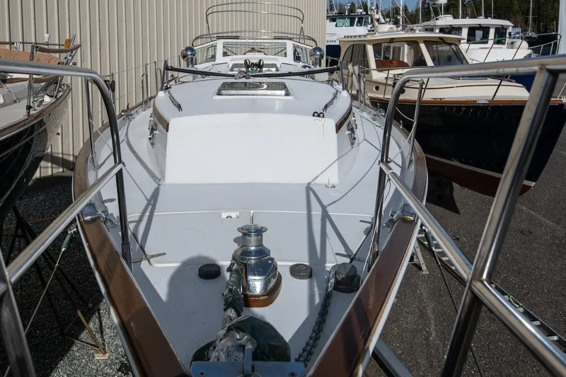 Slide: The Image of 1999 Gozzard 37A sailboat docked, showcasing deck and railing details. - 9