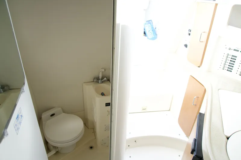 Slide: The Image of Compact bathroom in a 2000 Chris-Craft boat, featuring a toilet and sink. - 12