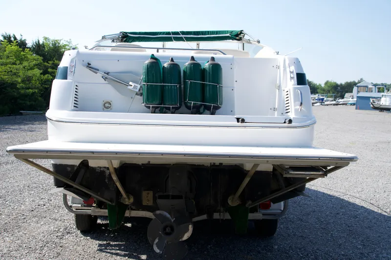 Slide: The Image of Rear view of a 2000 Chris-Craft boat with green fenders and outboard motor. - 3