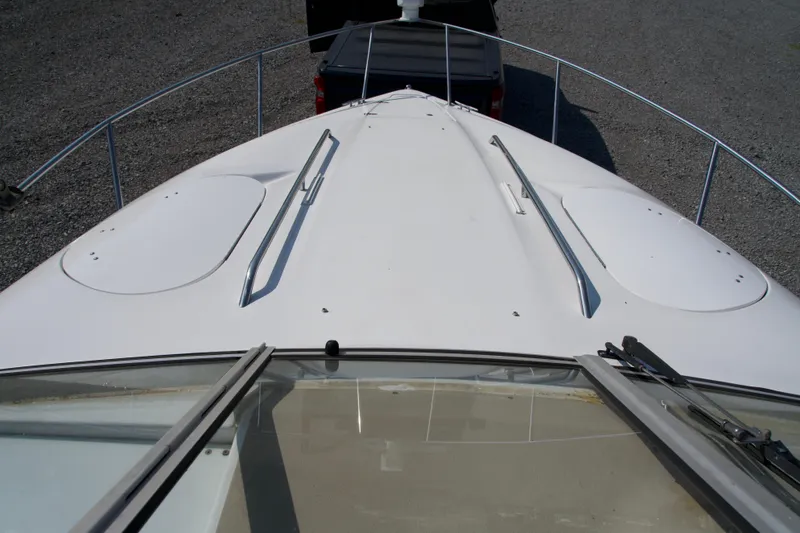 Slide: The Image of Bow view of a 2000 Chris-Craft boat on a trailer, showing deck and railings. - 6