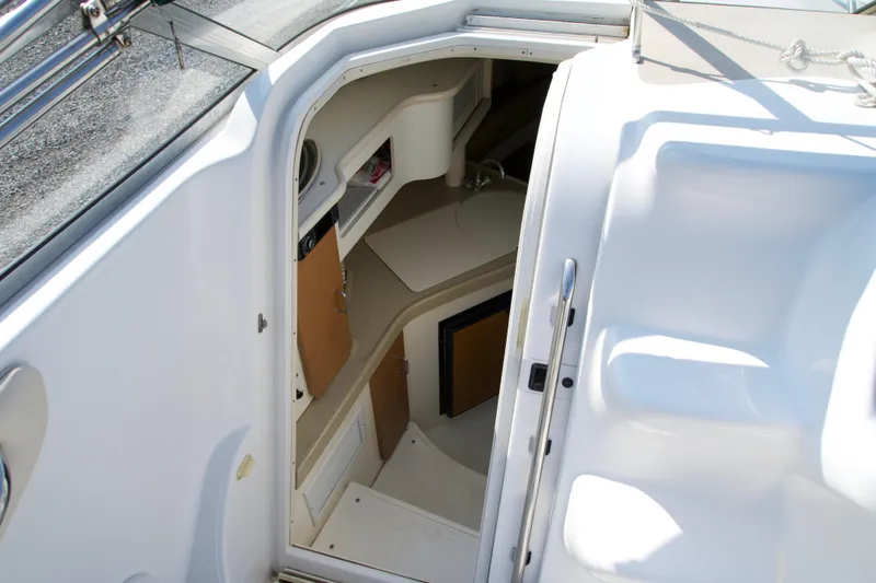 Slide: The Image of Interior view of a 2000 Chris-Craft boat cabin with compact kitchenette. - 7