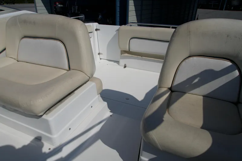 Slide: The Image of 2000 Chris-Craft boat interior with beige seating and white deck. - 8