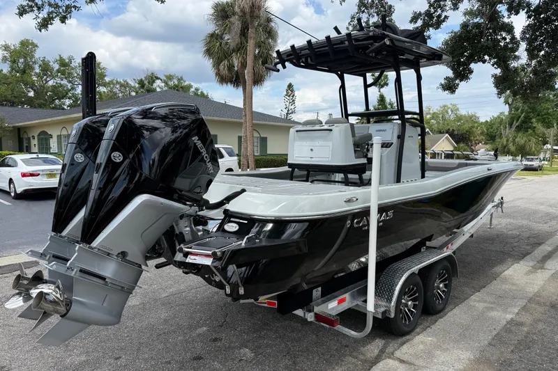Slide: The Image of 2025 Caymas 281 HB boat on trailer with dual Mercury outboard engines. - 12