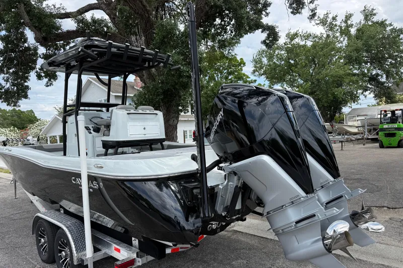 Slide: The Image of 2025 Caymas 281 HB boat with dual Mercury engines on a trailer. - 13