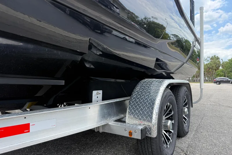 Slide: The Image of Trailer of 2025 Caymas 281 HB boat with dual wheels and metallic finish. - 15