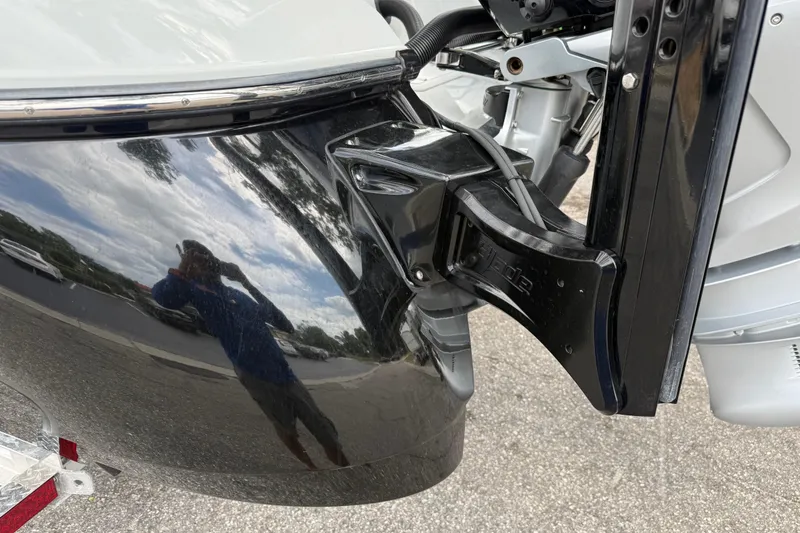 Slide: The Image of 2025 Caymas 281 HB boat with reflective black hull and motor mount detail. - 16