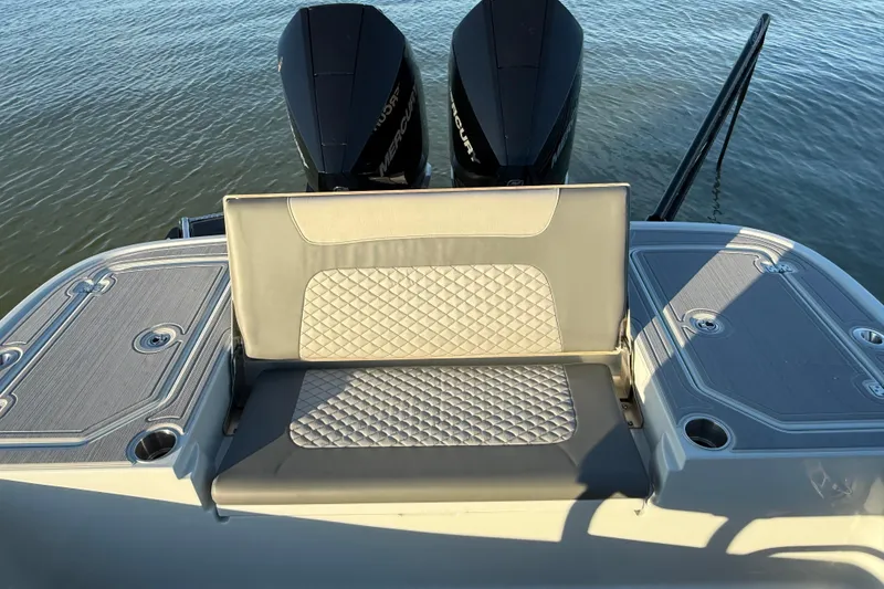 Slide: The Image of 2025 Caymas 281 HB boat with dual Mercury engines and cushioned seating. - 20