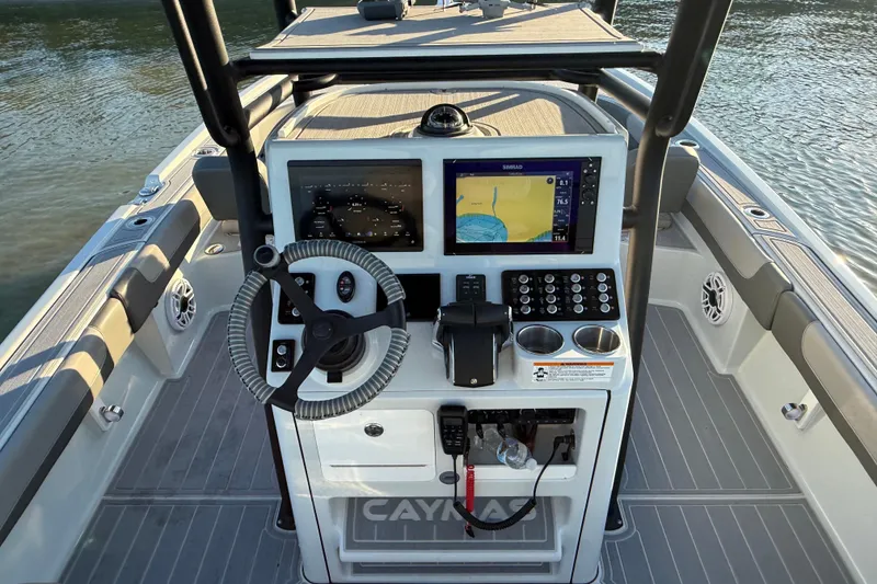 Slide: The Image of 2025 Caymas 281 HB boat dashboard with navigation system and controls. - 32