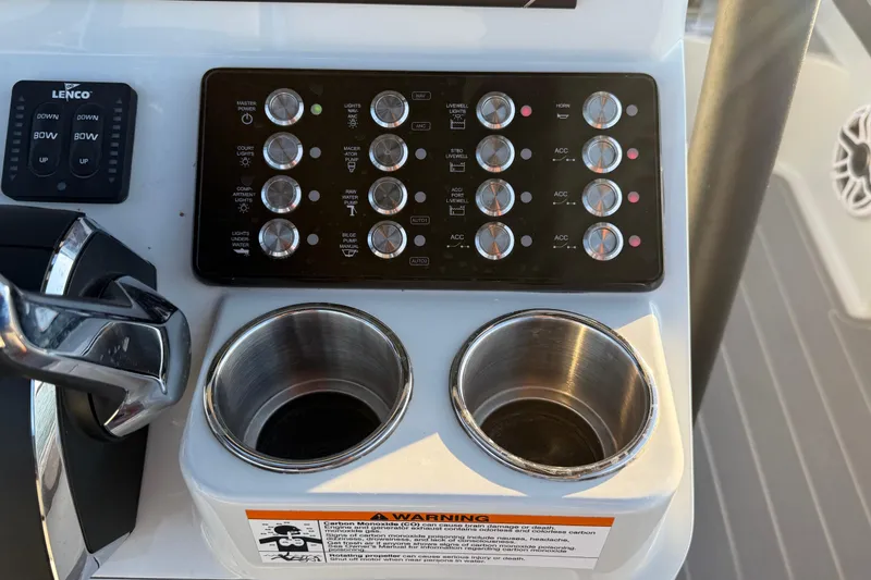 Slide: The Image of Control panel of 2025 Caymas 281 HB boat with switches and cup holders. - 38