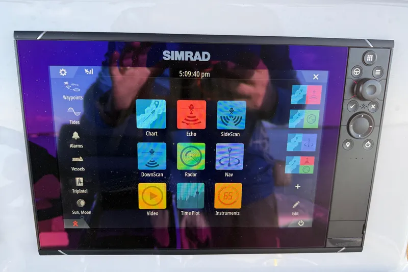 Slide: The Image of Simrad marine display on 2025 Caymas 281 HB boat, showing navigation and sonar options. - 41